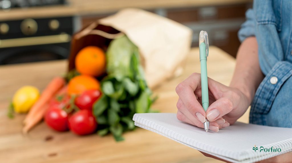 A person calculating the cost of buying organic food.