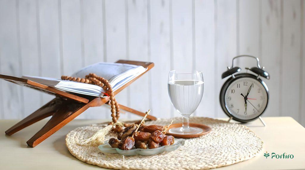 A table clock next to a glass of water and a basket containing dates, the Quran, and rosary beads.