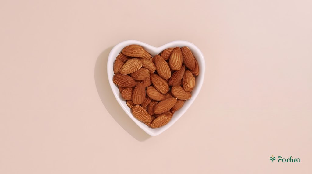 A small heart-shaped container containing almond kernels.