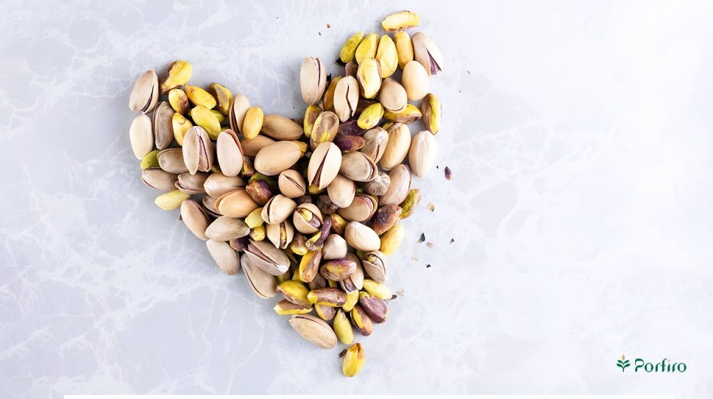 A heart shape is made with some inferior pistachios.