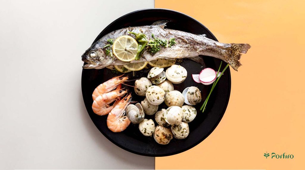 A seafood platter featuring a whole fish, a known cause of allergies