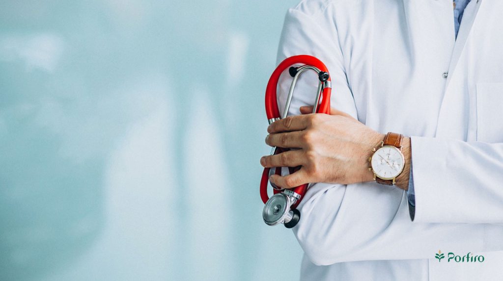 A person in a white coat holding a stethoscope