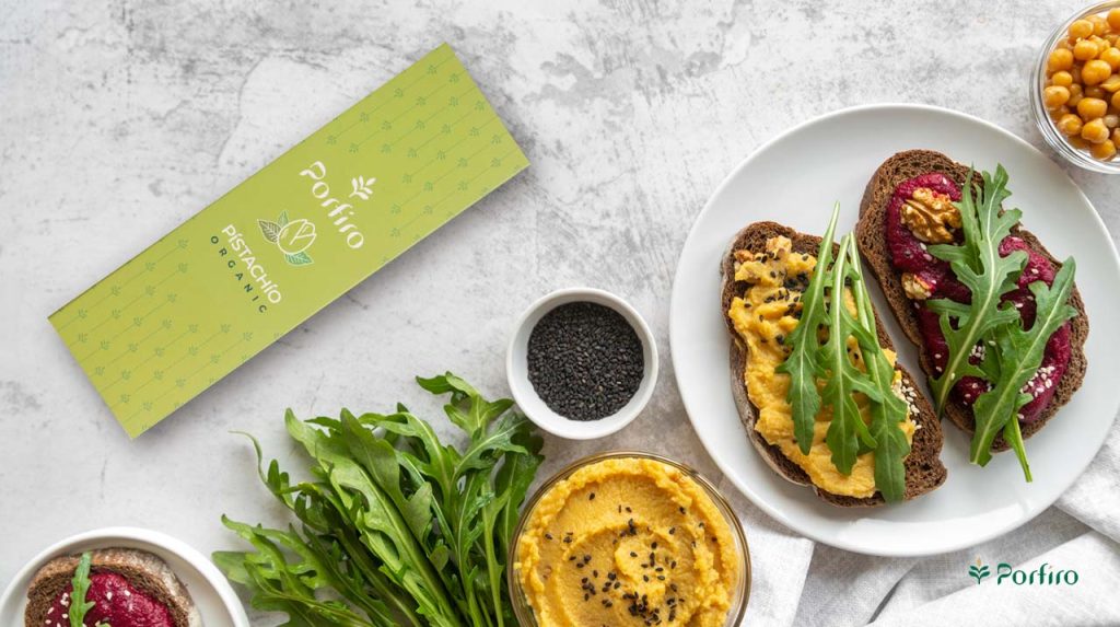 Healthy and varied dishes prepared on toast alongside a pack of Porfiro pistachios