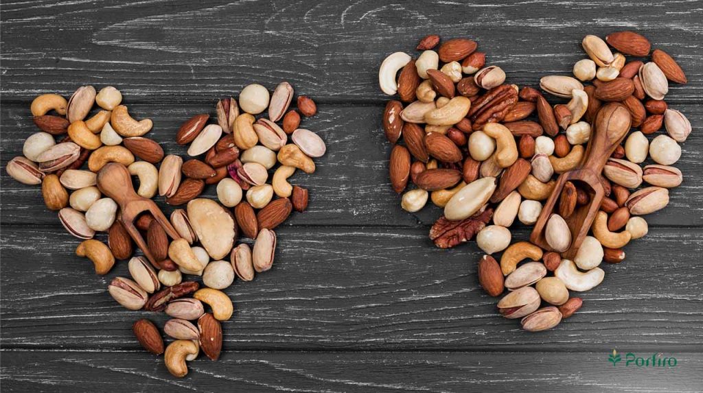 A mixture of nuts together create the design of two hearts.