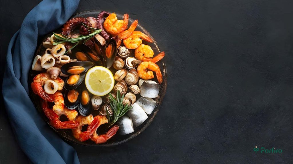 A large container containing various types of shellfish and shrimp, which are known to cause allergies in some people.