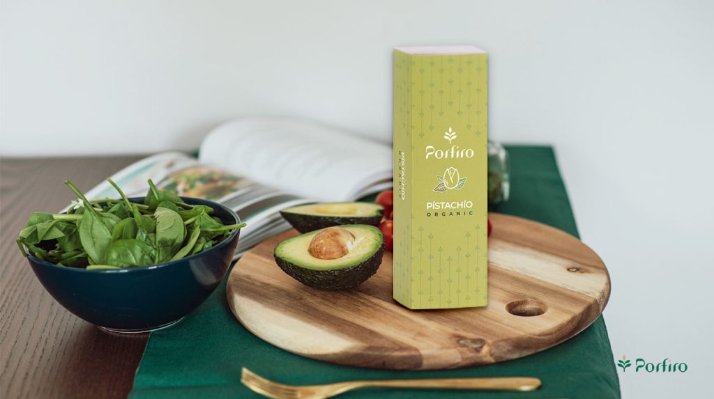 A package of Porfiro pistachios on the kitchen counter and an avocado next to it, ready to use.