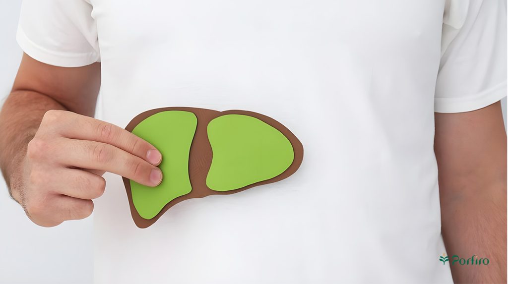 A man holds a paper liver shaped like a man's head and places it face down on his body