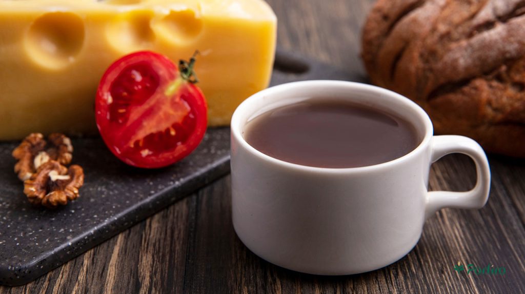 A cup of tea with a slice of cheese