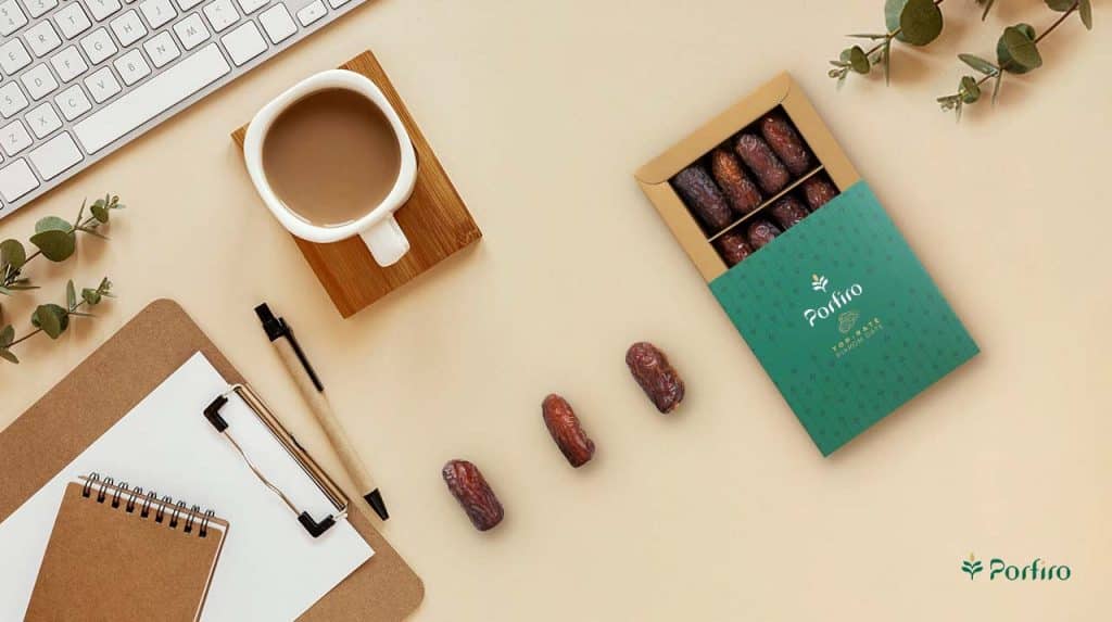 A pack of Piarom Porfiro dates and some date seeds on the work table, a convenient and energetic snack