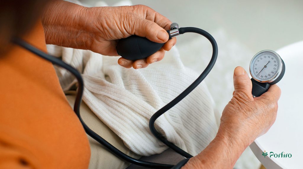 A person is measuring their blood pressure using a blood pressure monitor.