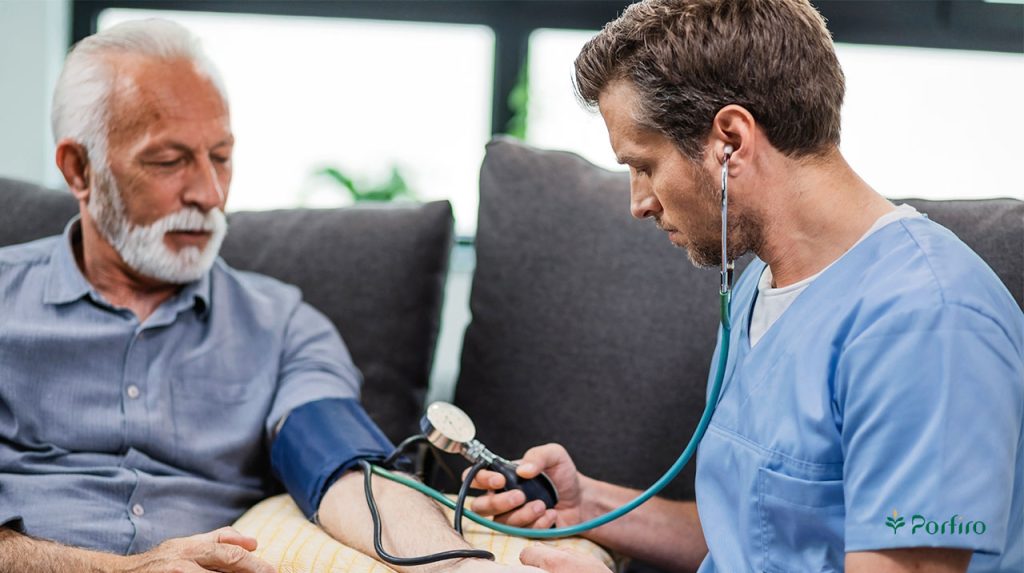 Doctor measuring blood pressure of elderly man