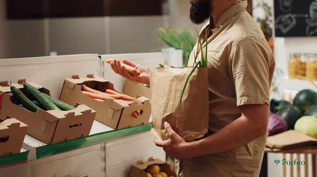 A consumer is checking the quality of agricultural products in the store in the format of The role of consumers in supporting farmers and farm workers for the article International Farm Workers Day on the Porfiro blog.