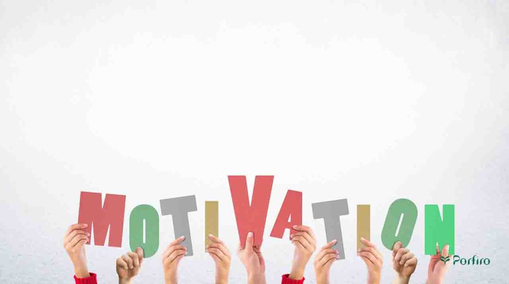 The letters of the word motivation in English on different cards in different hands