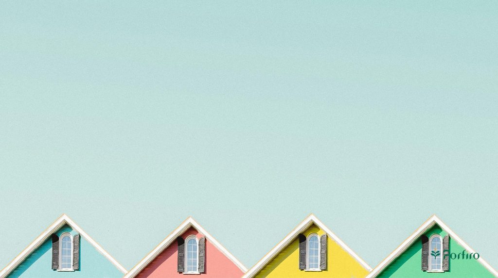 A simple and minimalist view of a row of fancy houses in pastel colors, a symbol of simplicity in minimalist design and decoration for the article Minimalist Lifestyle: How Can Simplicity Help Reduce Stress?