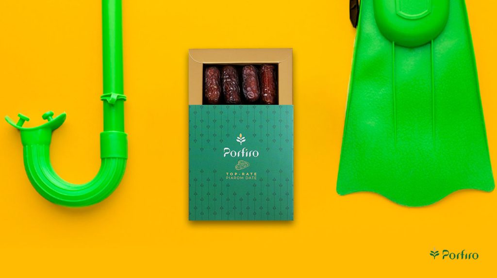 Diving fins and a pack of Piarom Porfiro dates for the article Swimming Nutrition: How to Fuel Your Body for Better Results
