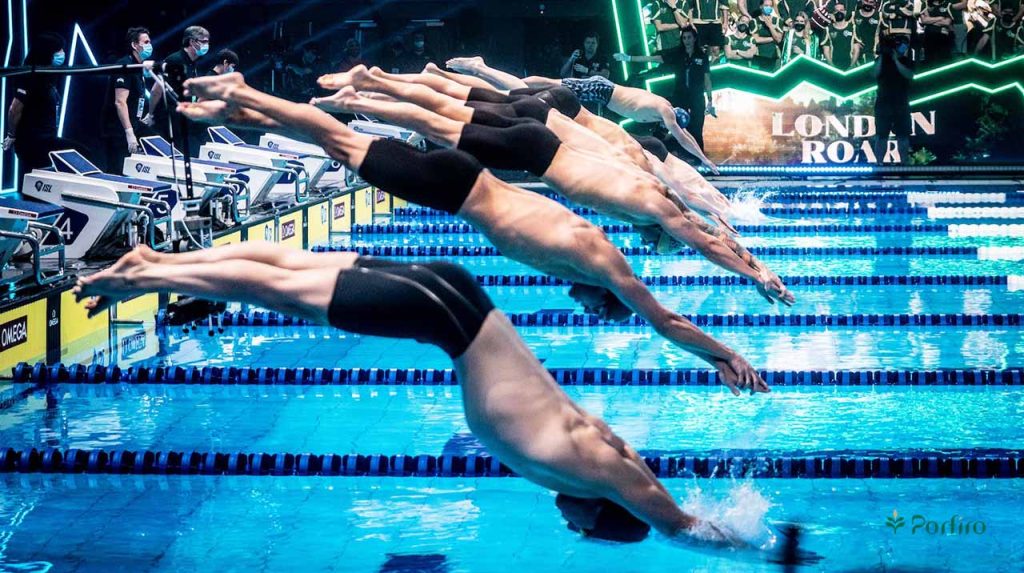 The moment the swimming race begins and the swimmers dive into the water for the article Swimming Nutrition: How to Fuel Your Body for Better Results